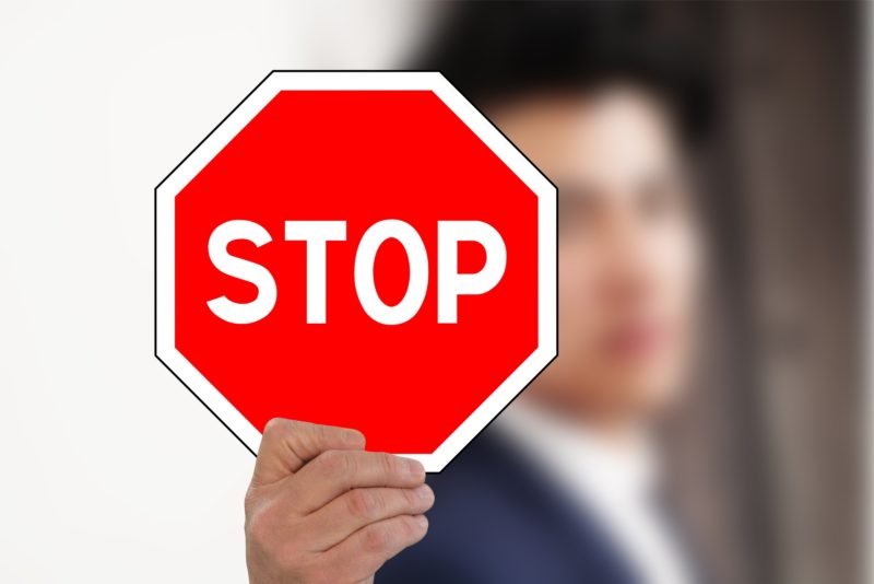 person holding stop sign
