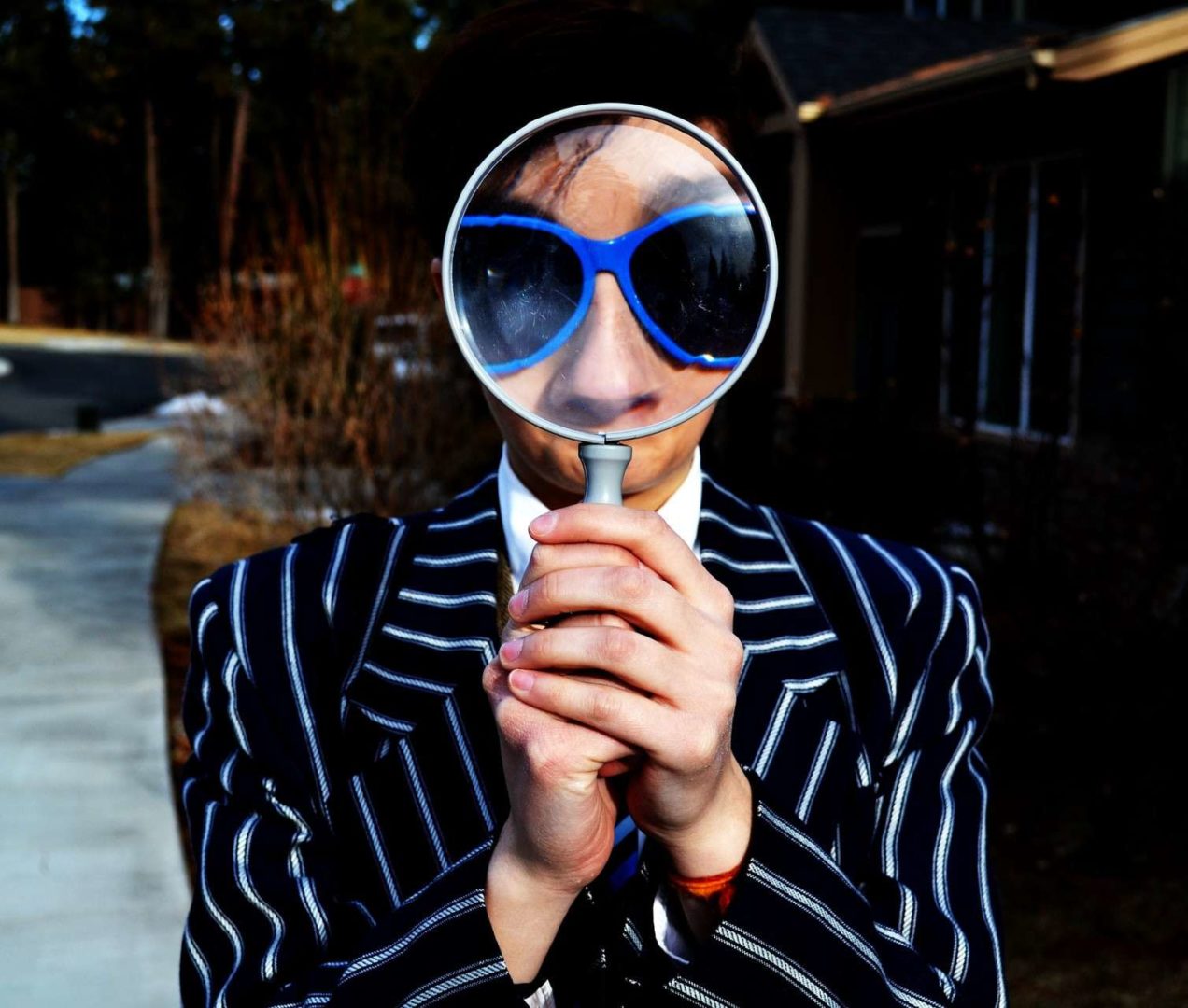 person holding magnifying glass